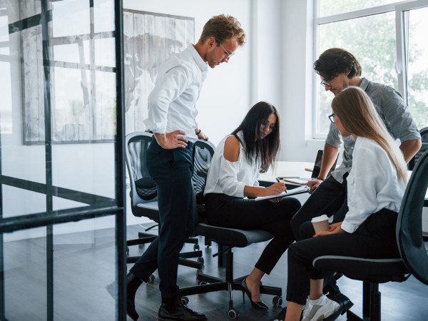People conversing in an office meeting room