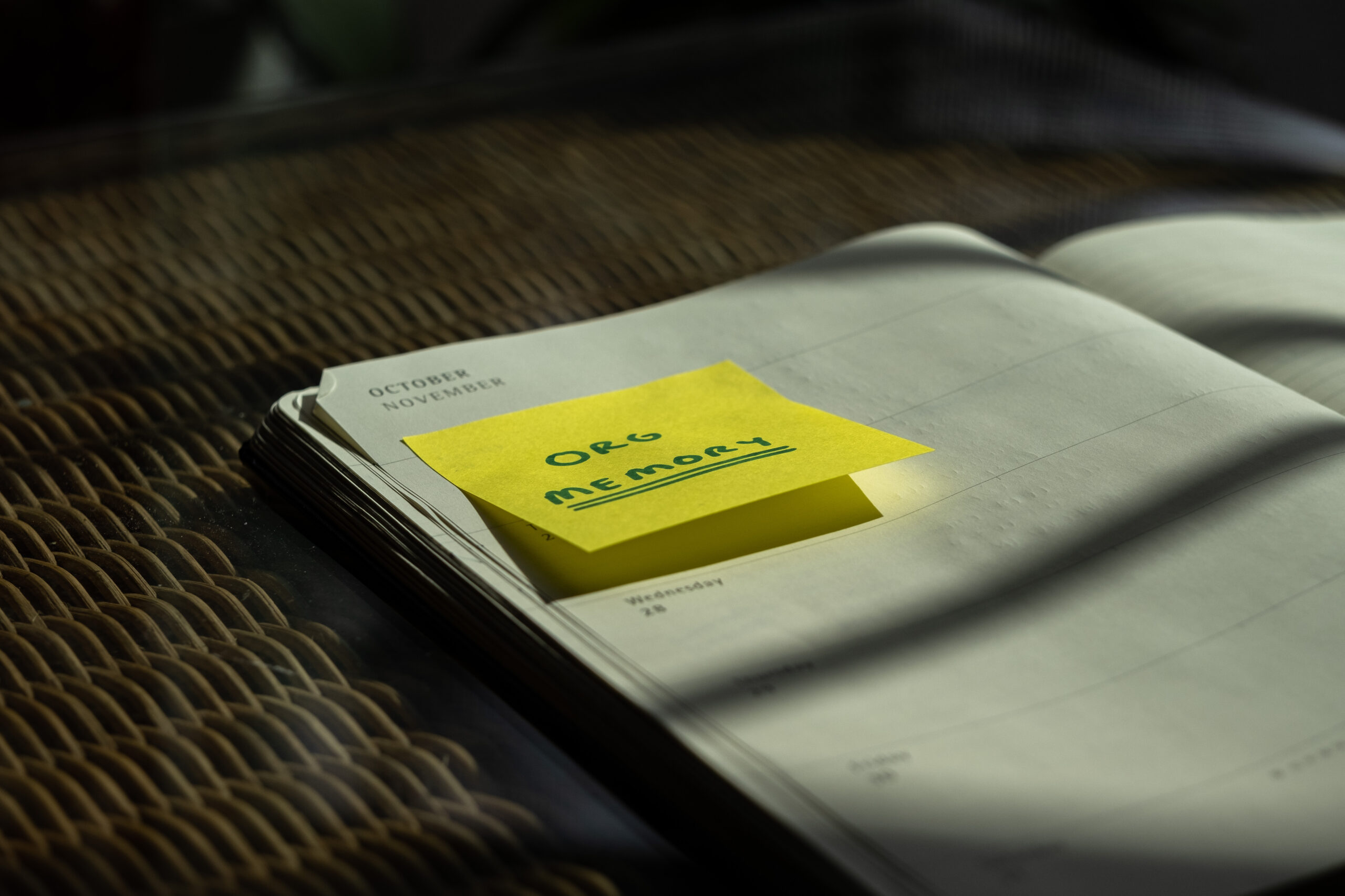 A notebook with a yellow sticky note