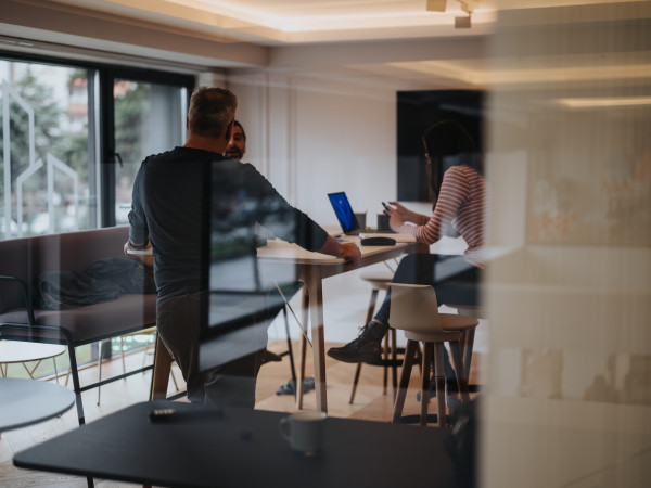 Blurred image showing people meeting in an office