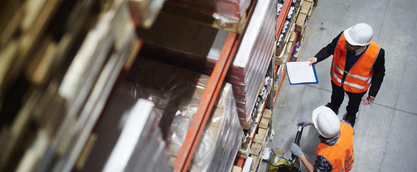 Men in a warehouse looking at a tablet