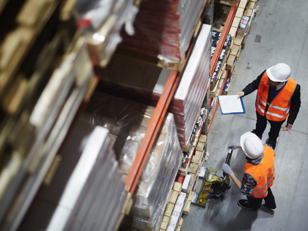 Men in a warehouse looking at a tablet