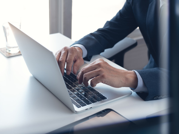 Image of a man working on a laptop