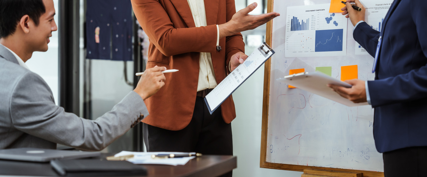 Business people meeting around a white board