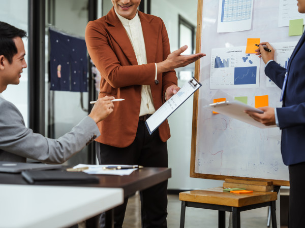 Business people meeting around a white board