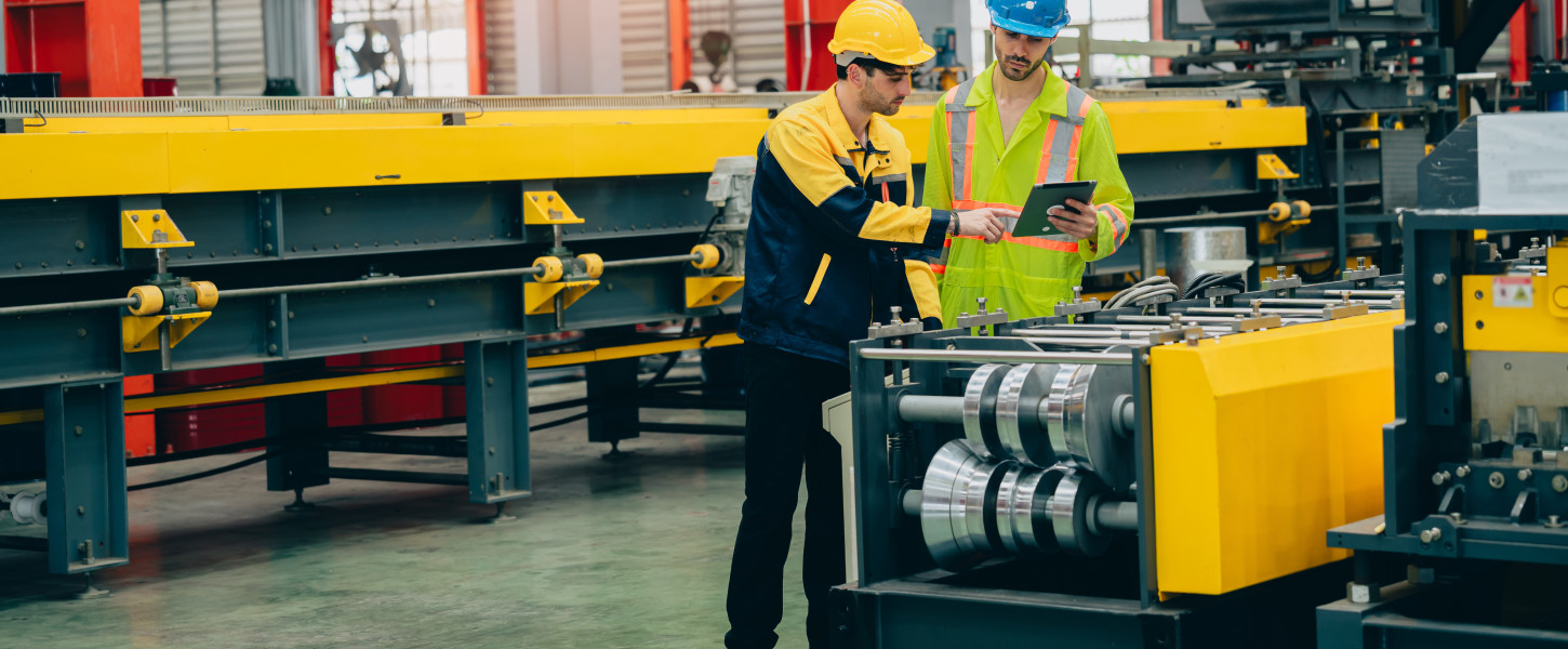 Factory workers inspecting a machine