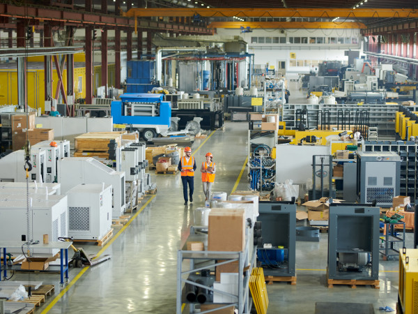 Construction workers walking in a warehouse