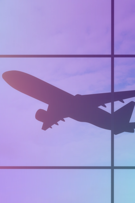 Image of plane in the sky through a window